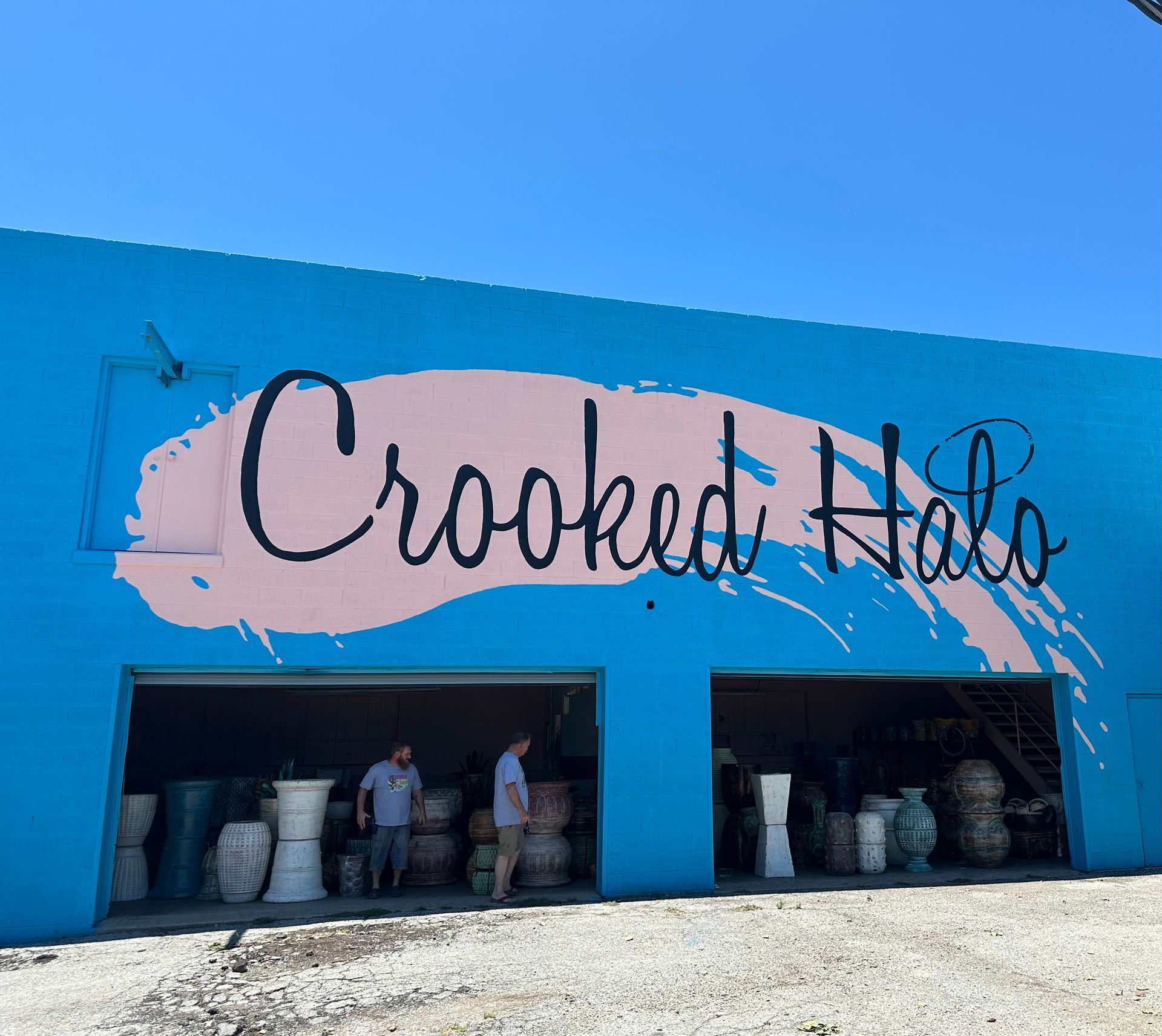 A blue building with the words crooked halo painted on it