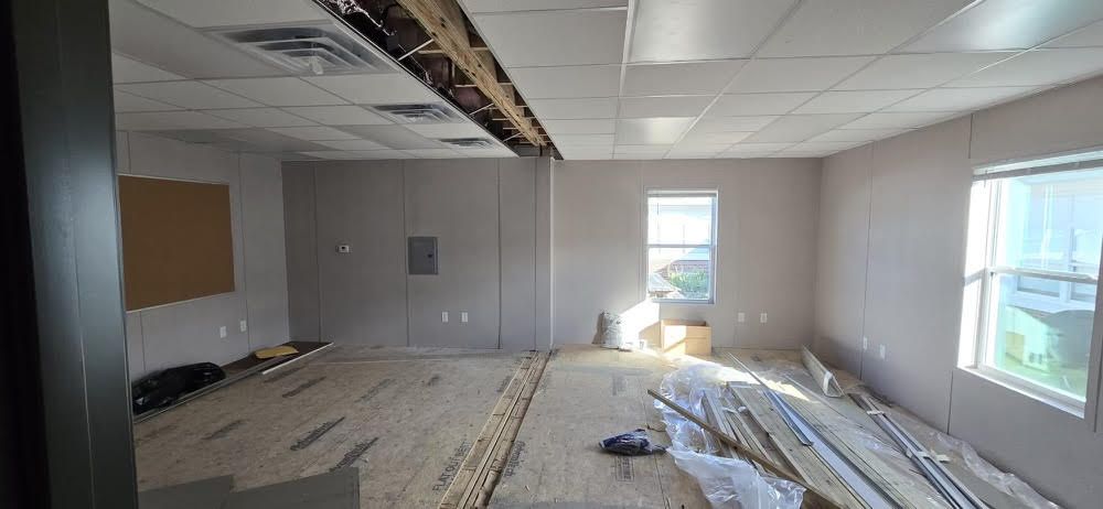 A room with a lot of boxes on the floor and a window.