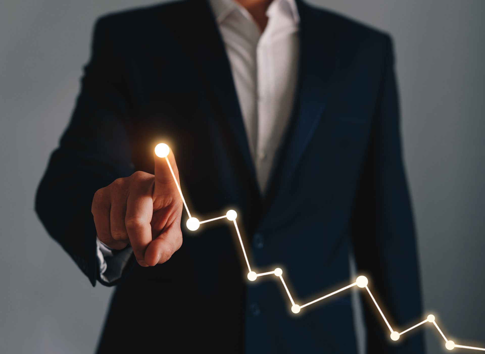 Business man pointing at a negative graph