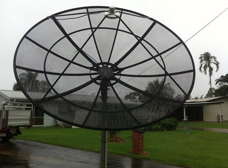 A Large Satellite Dish is Sitting in Front of a House — Hendo's TV Antennas & Installations in White Rock, QLD