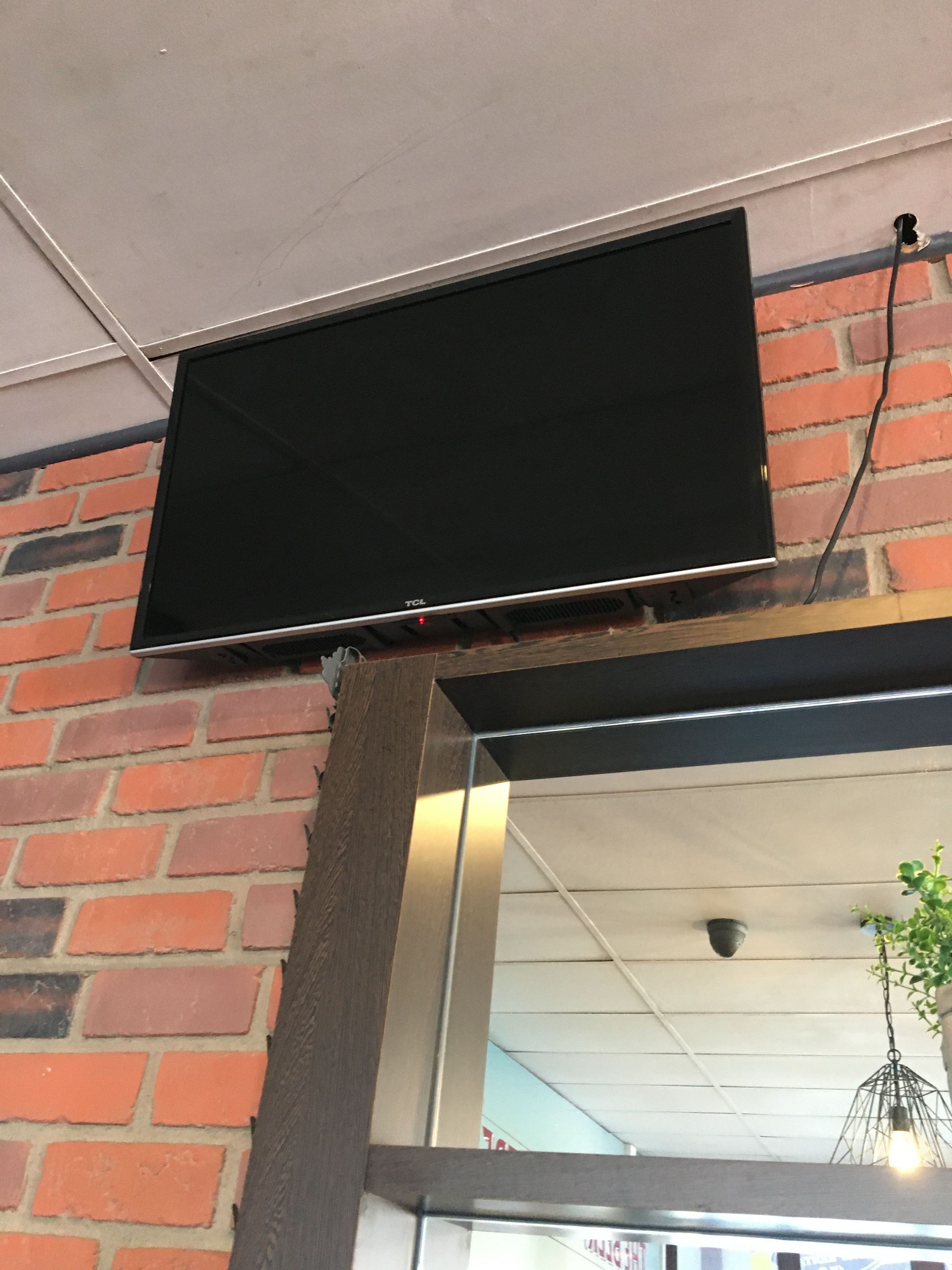A Tv Mounted to a Wall With a Bunch of Wires Coming Out of It — Hendo's TV Antennas & Installations in White Rock, QLD