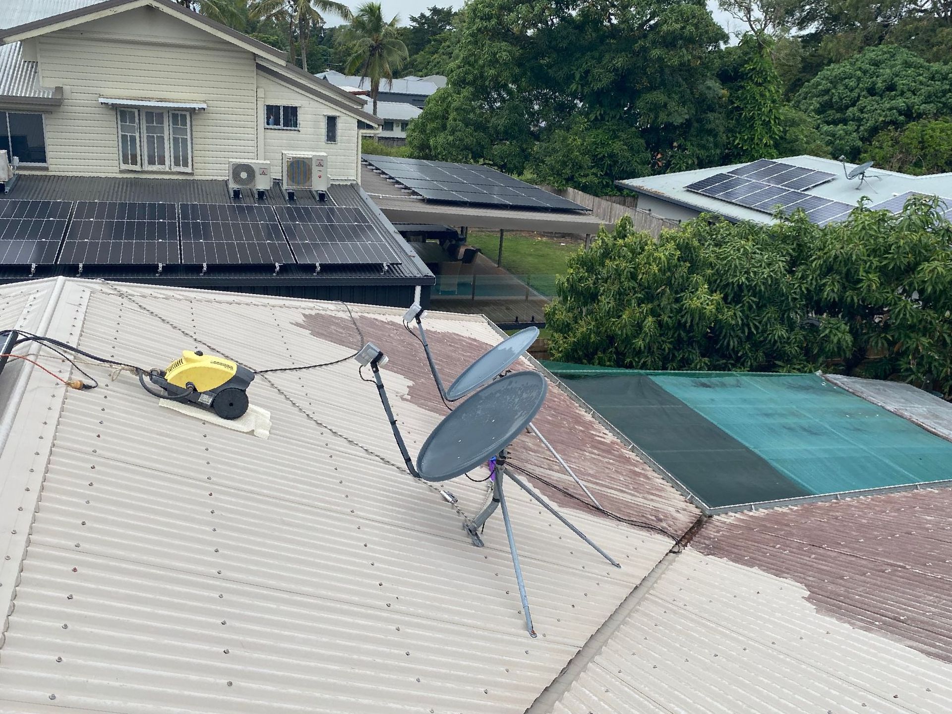 A Black Box is Attached to a Metal Pole on a Roof — Hendo's TV Antennas & Installations in Innisfail, QLD