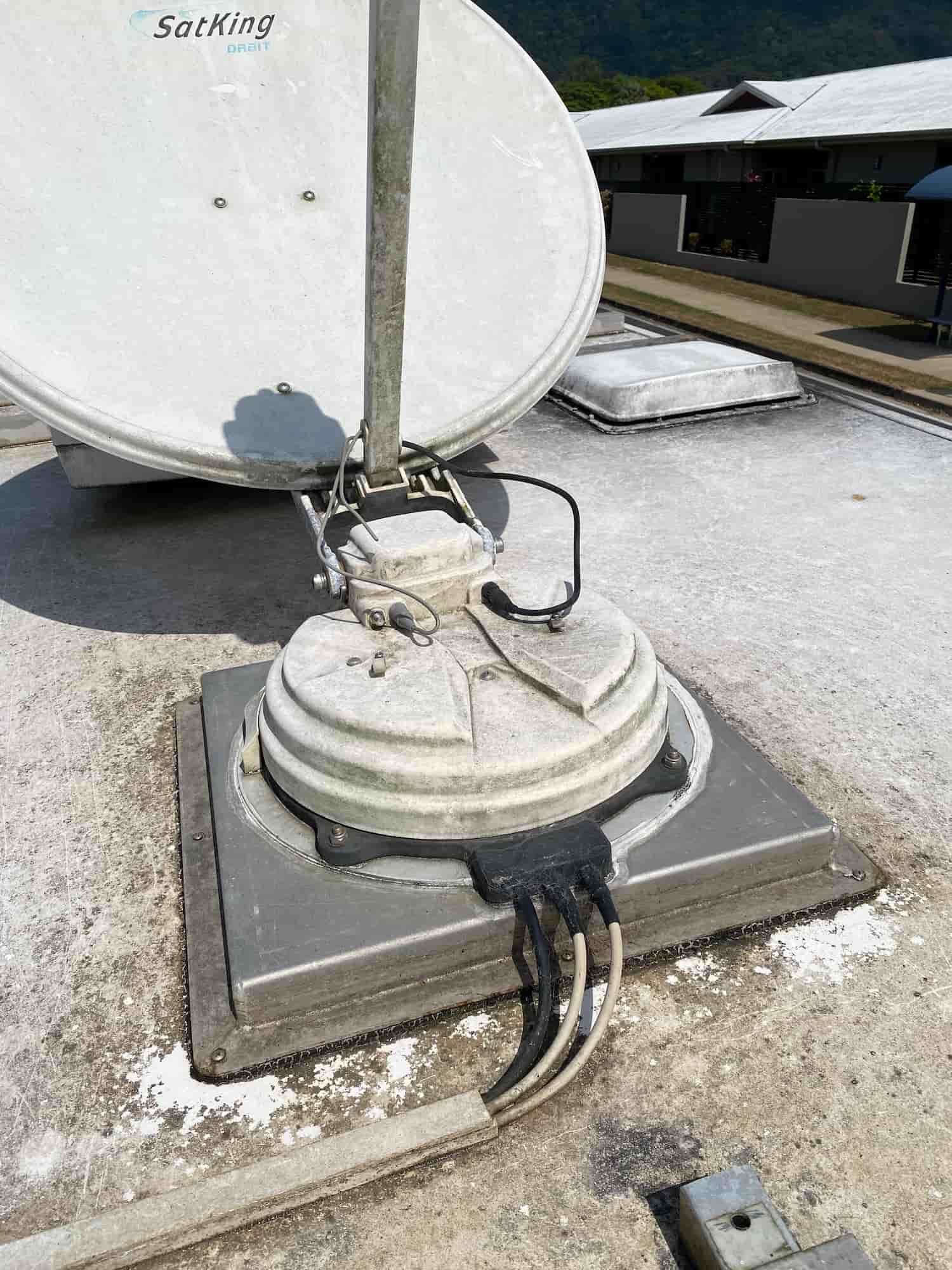 A Satellite Dish is Sitting on Top of a Concrete Base on a Roof — Hendo's TV Antennas & Installations in White Rock, QLD