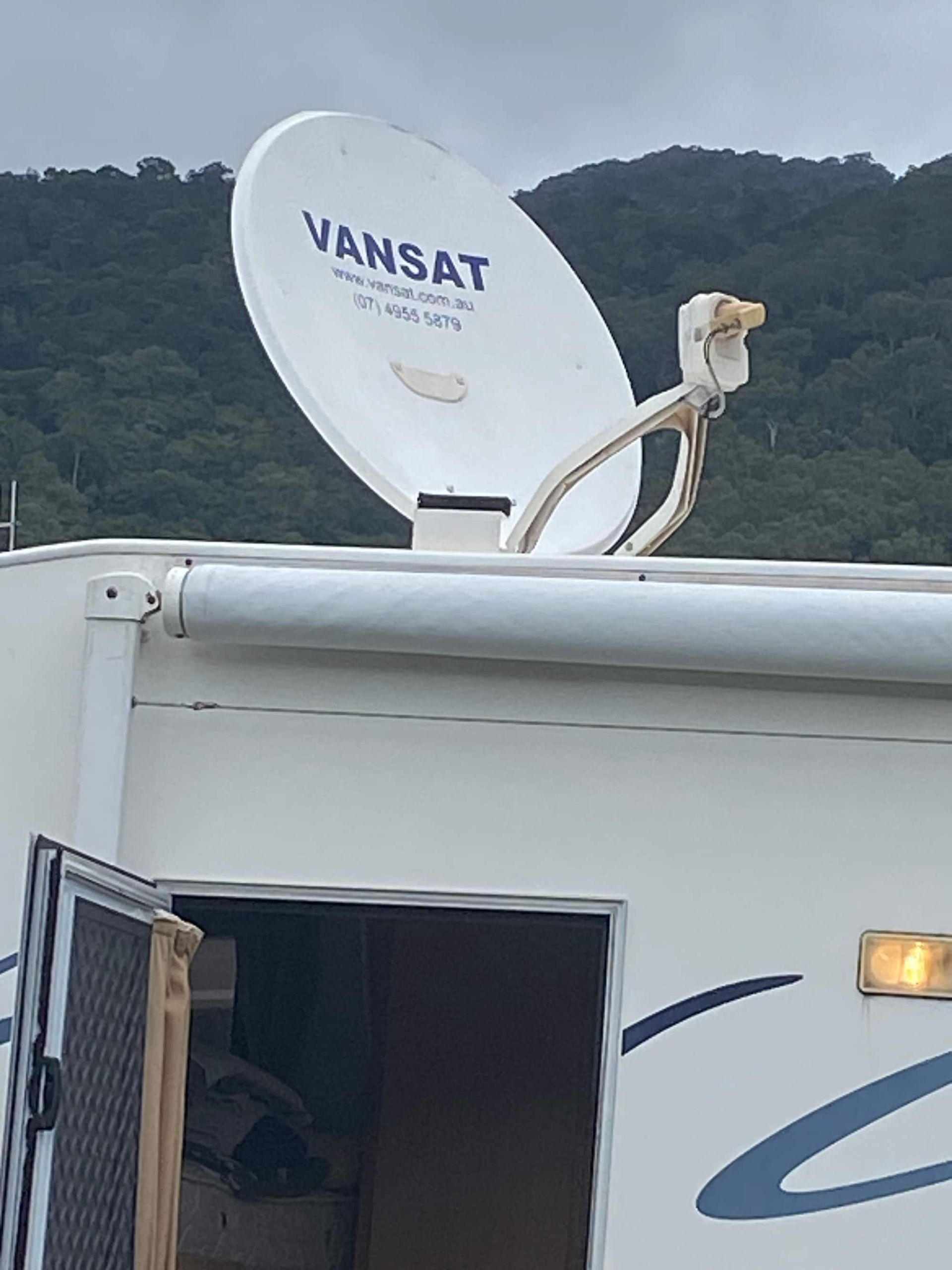 A Vansat Satellite Dish on Top of a White Rv — Hendo's TV Antennas & Installations in Innisfail, QLD