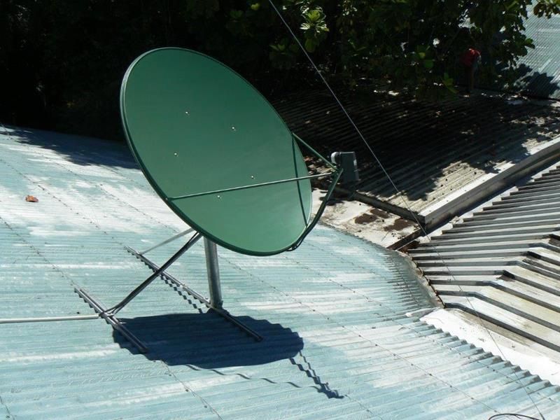A Green Satellite Dish Sits on Top of a Blue Roof — Hendo's TV Antennas & Installations in White Rock, QLD
