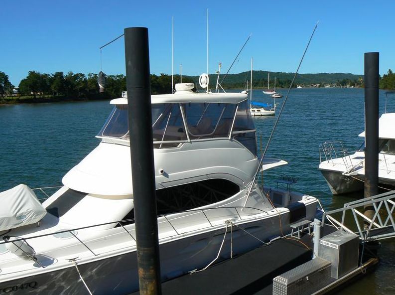 A White Boat is Docked at a Dock and Has the Word Carra on the Side — Hendo's TV Antennas & Installations in White Rock, QLD