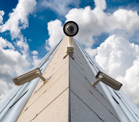 Two Security Cameras Are Mounted on the Corner of a Building — Hendo's TV Antennas & Installations in White Rock, QLD