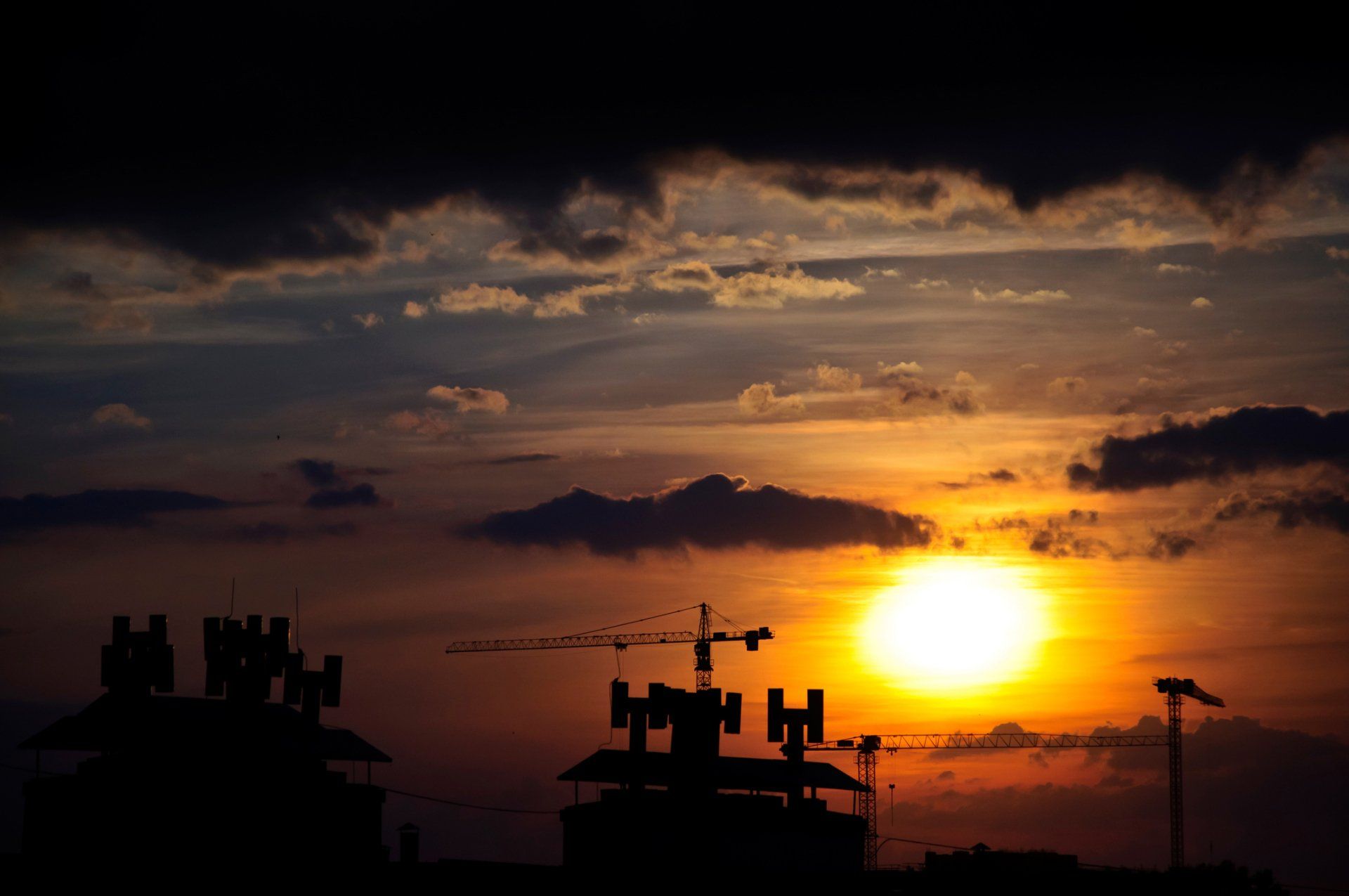 Sunset with Clouds Over the City with Cranes — Saint Petersburg, FL — On Demand Crane Service
