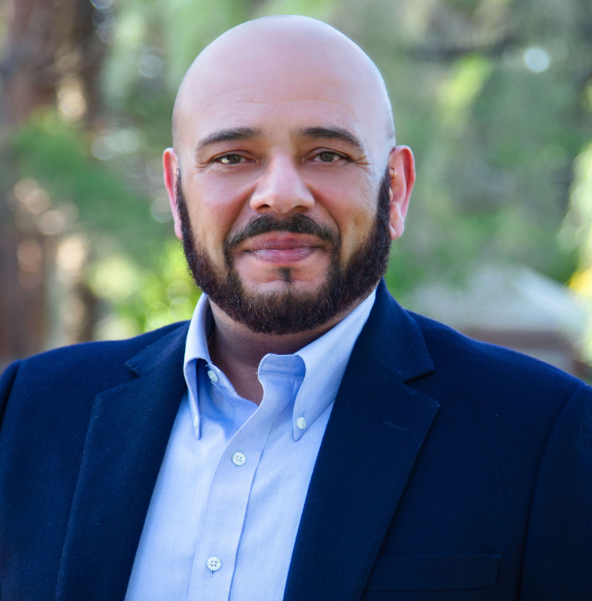 A woman wearing a white jacket and a gold watch