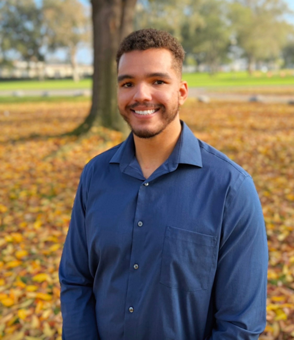 A woman wearing a white jacket and a gold watch