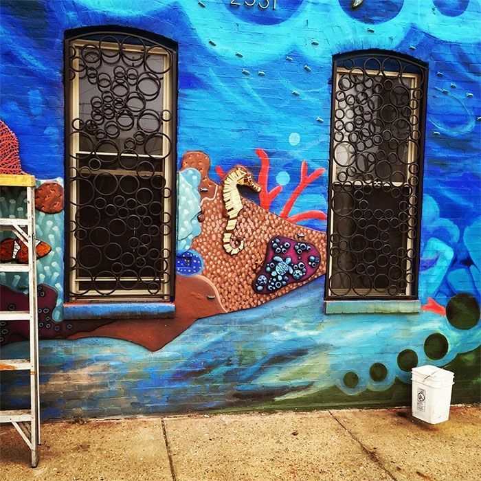 A seahorse is painted on the side of a building