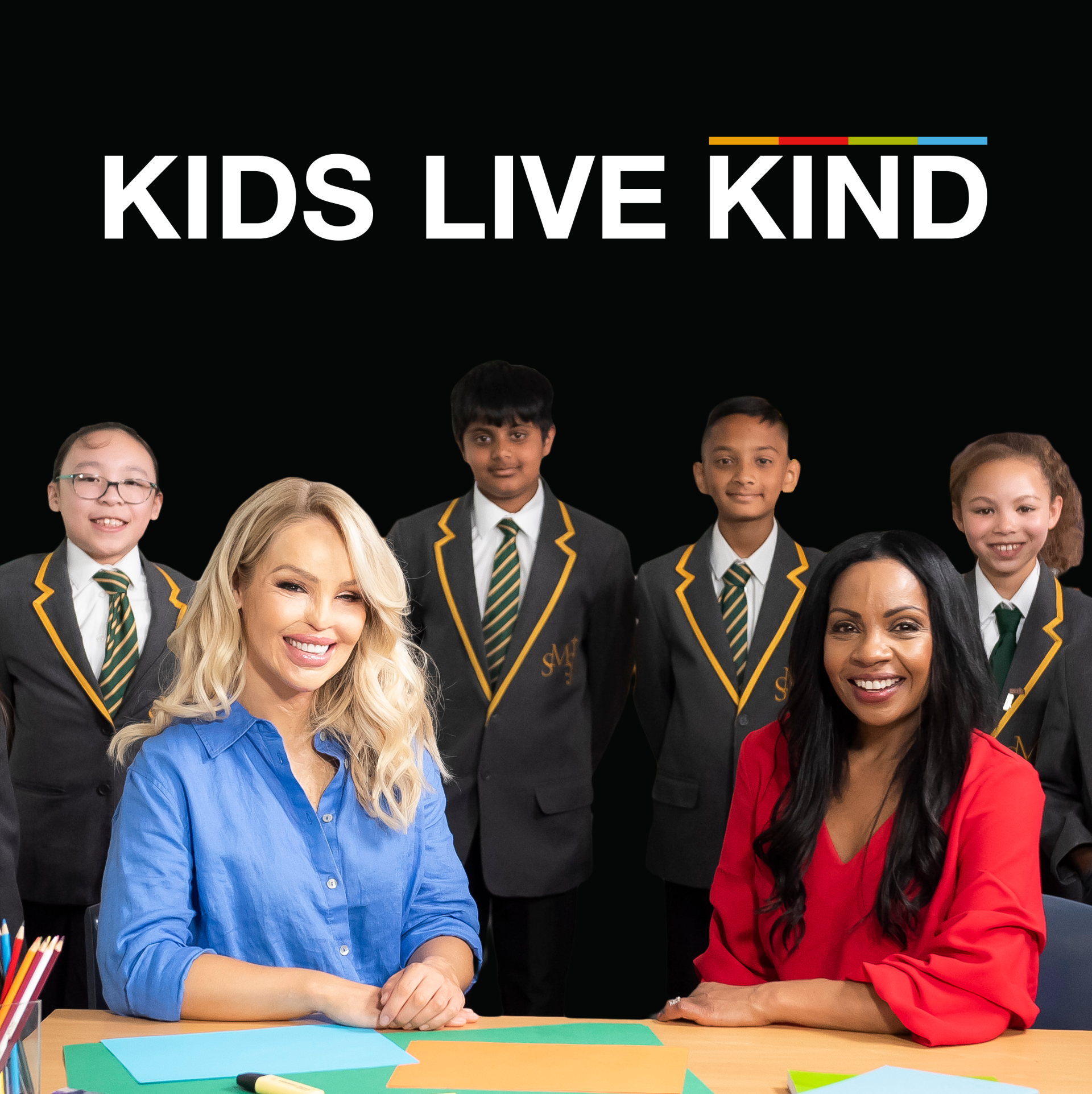 A group of children in school uniforms are sitting at a table with two women.