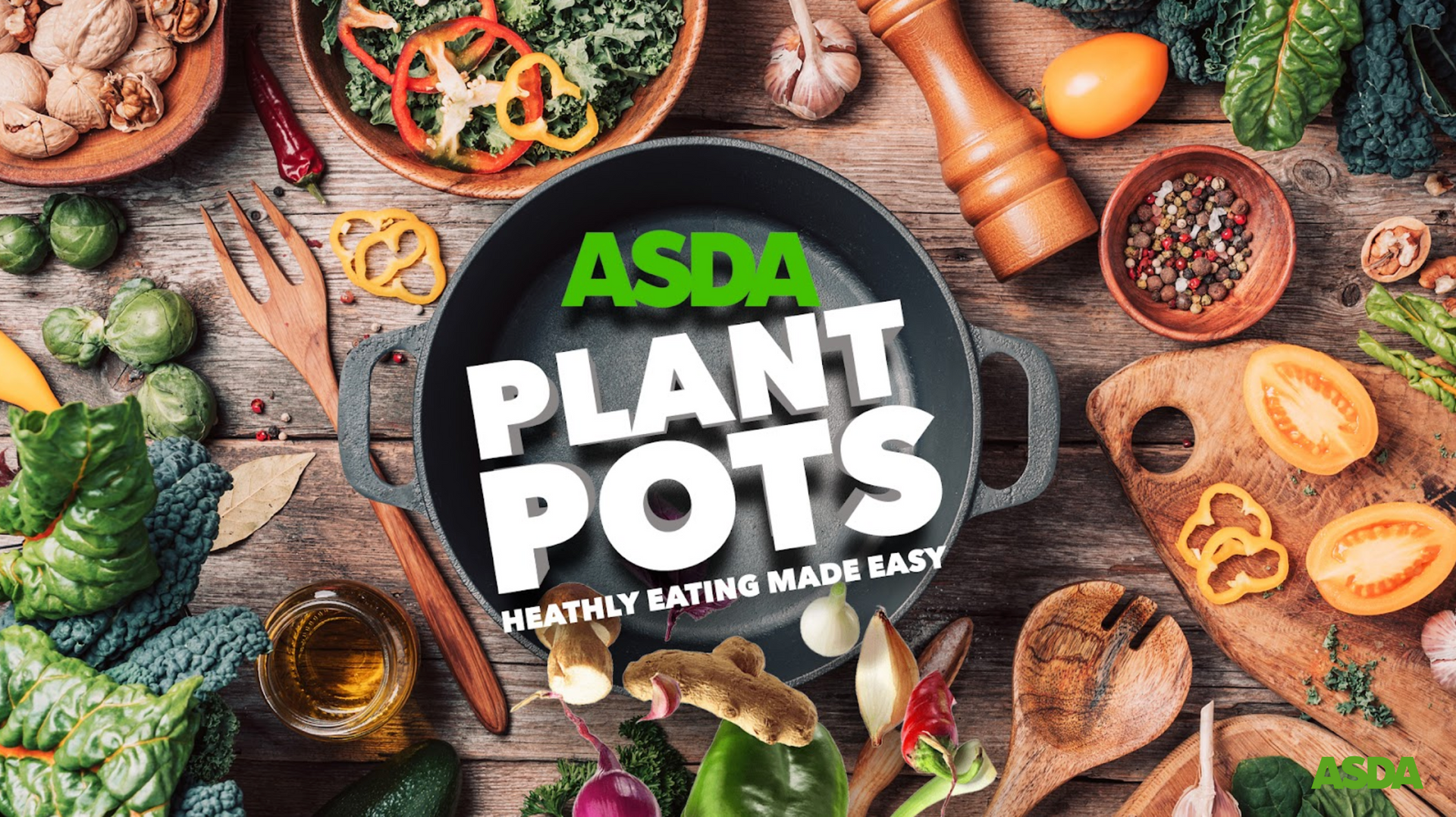 A wooden table topped with bowls of vegetables and a pan that says `` asda plant pots ''.