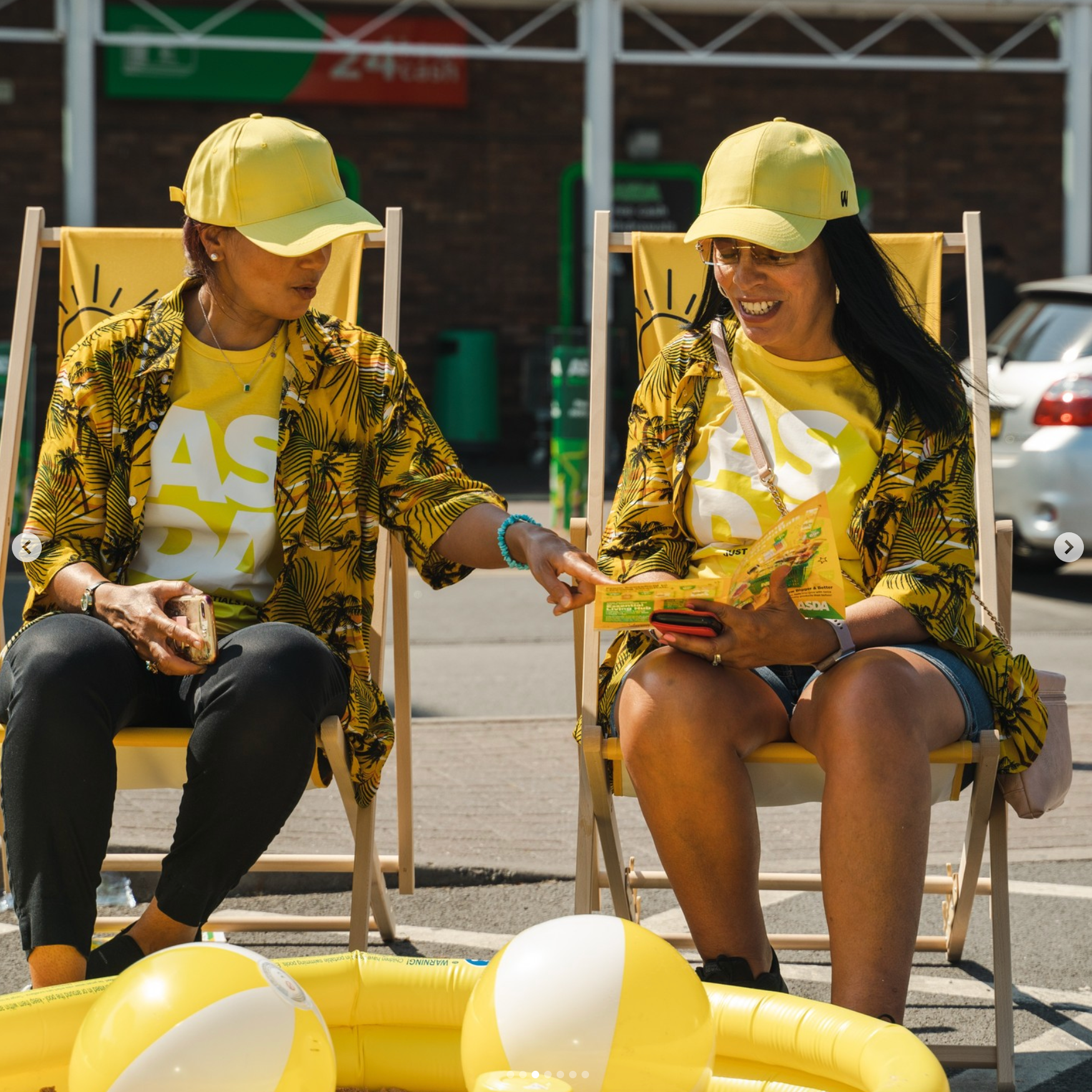 Two people sitting in yellow chairs next to a pool