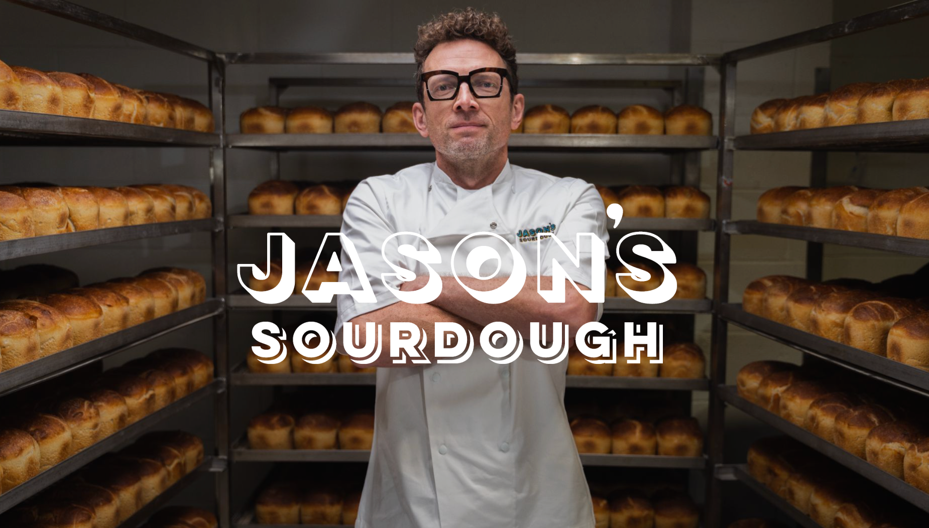 A man is looking at a large pile of dough.