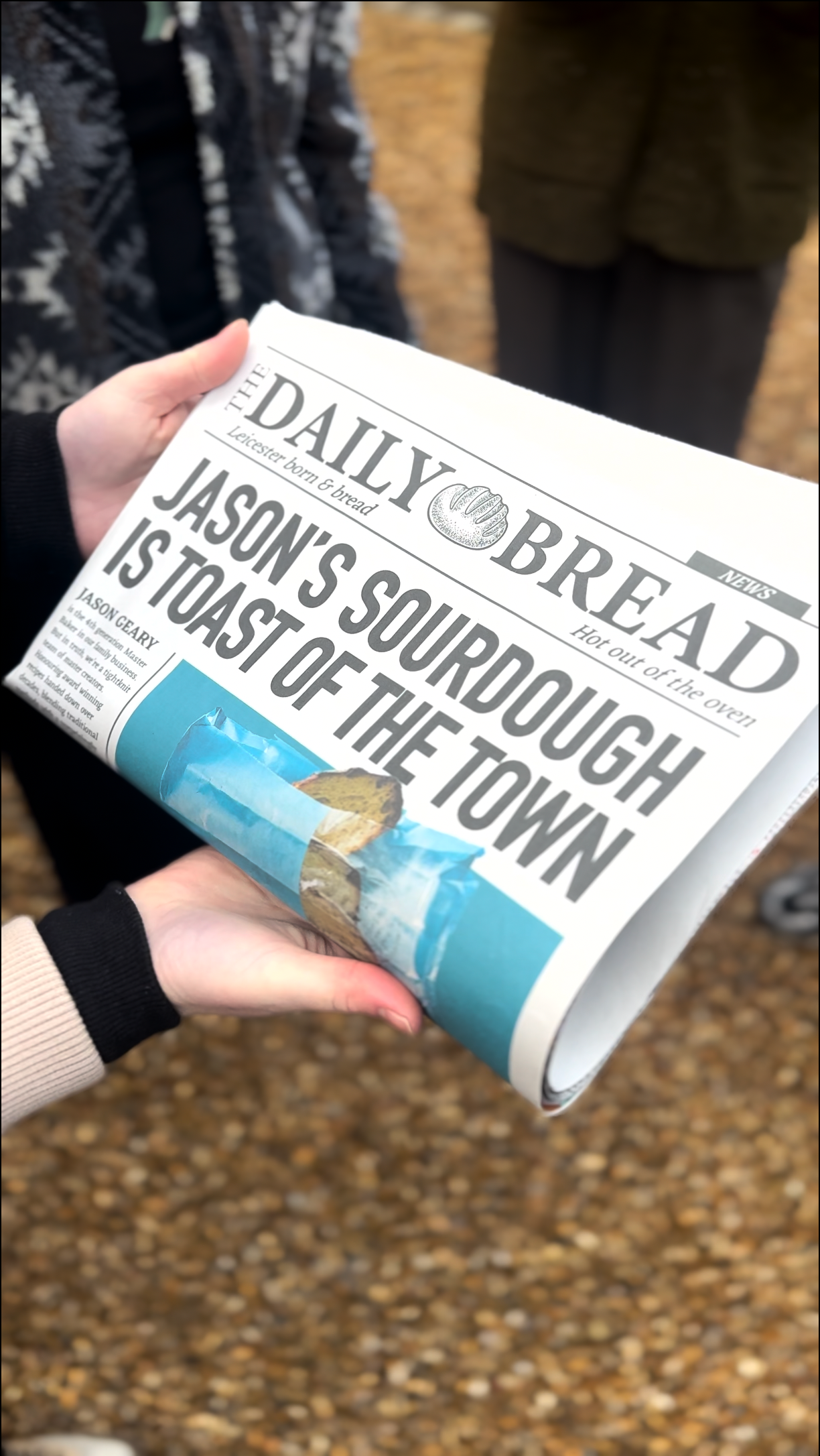 Person holding a newspaper with the headline