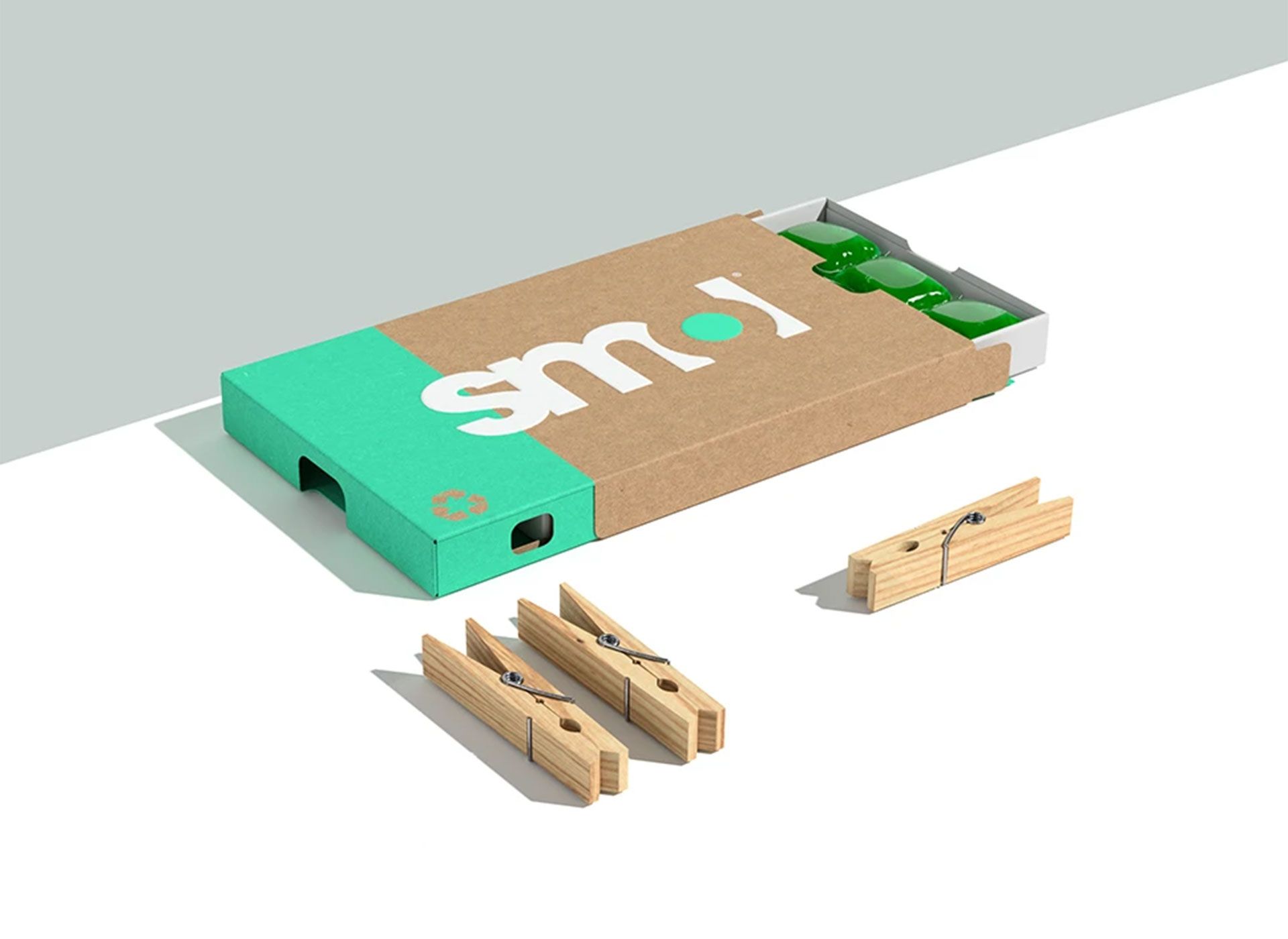 A box of wooden clothes pins is sitting on a table.