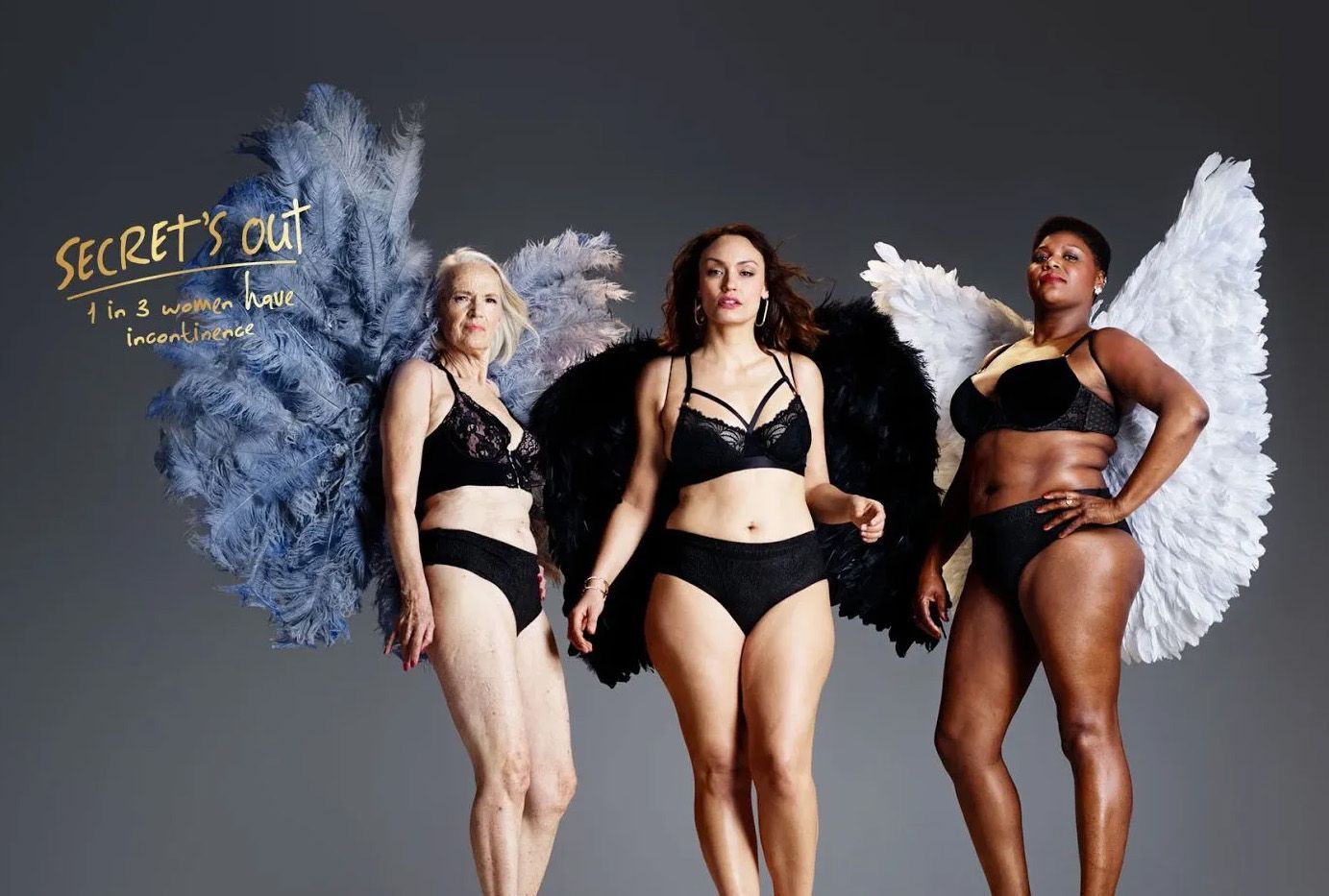 Three women in underwear and angel wings are standing next to each other.