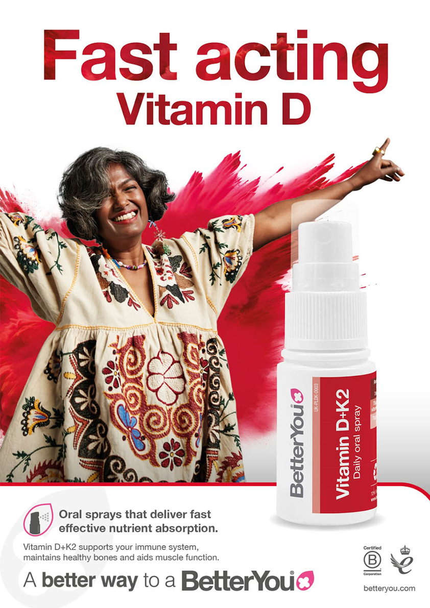 A woman is standing in front of a bottle of fast acting vitamin d.