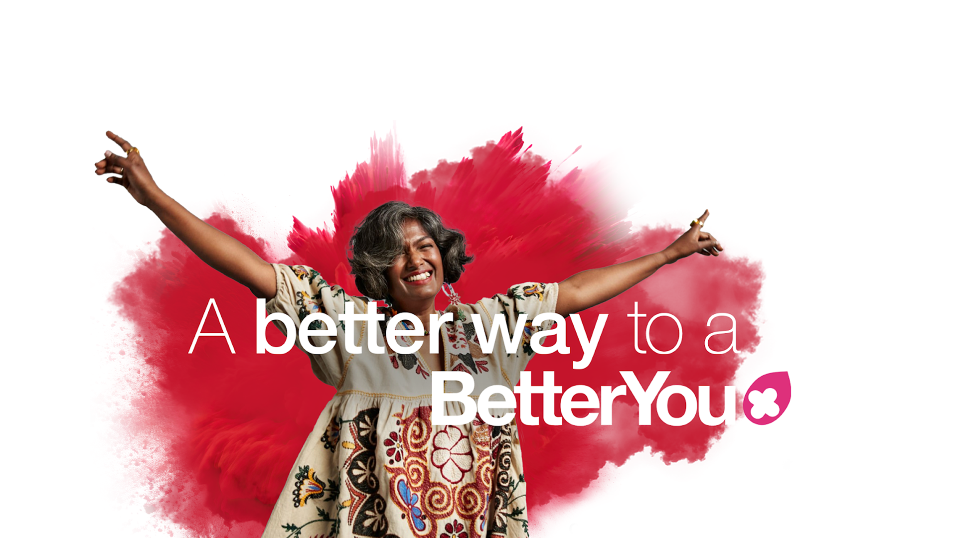A woman is standing in front of a red background with the words `` a better way to a better you ''.
