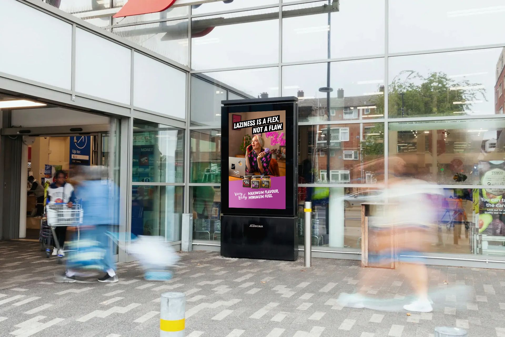 Digital advertisement outside of a store entrance, blurred people walk by.