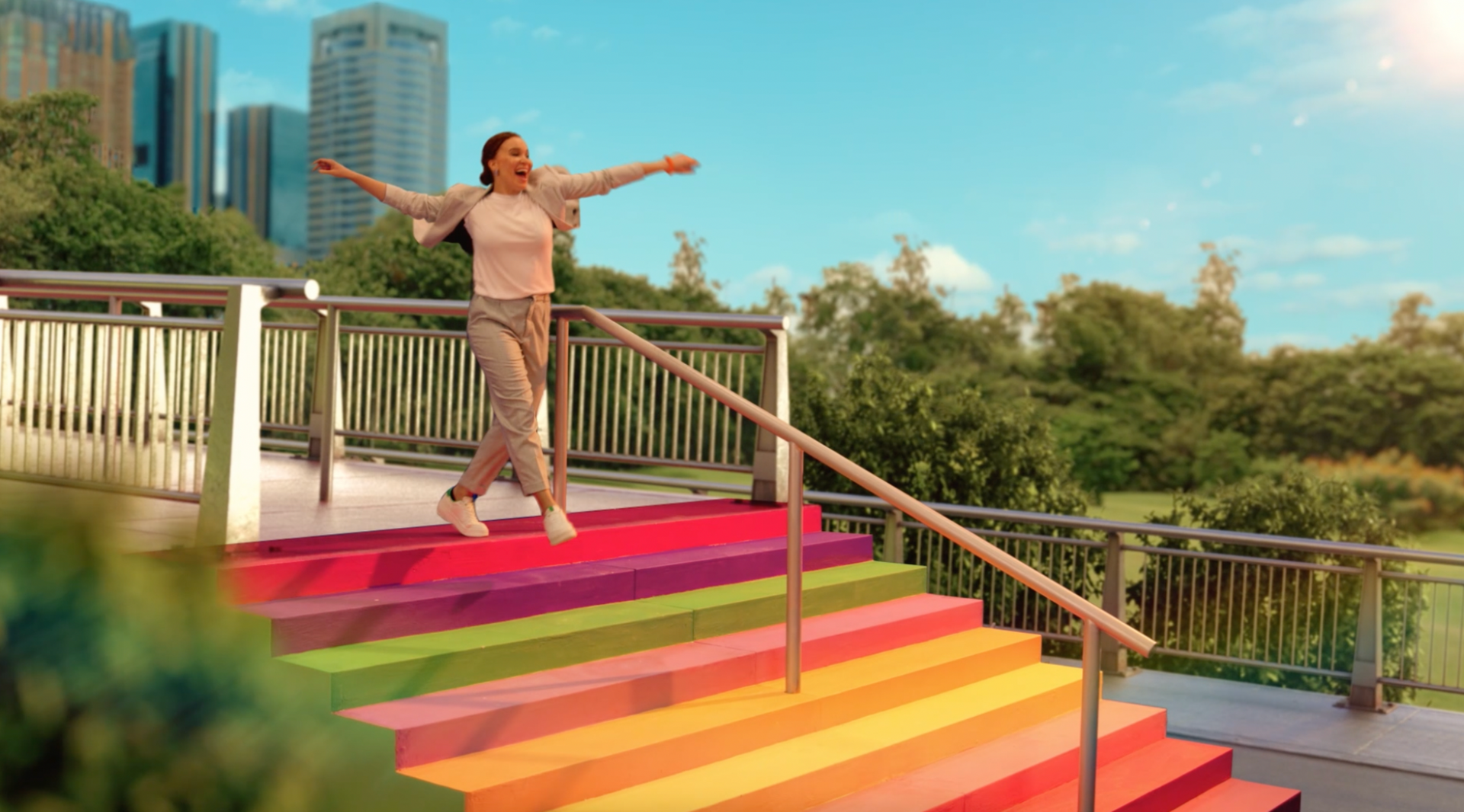 A woman is standing on a set of colorful stairs.