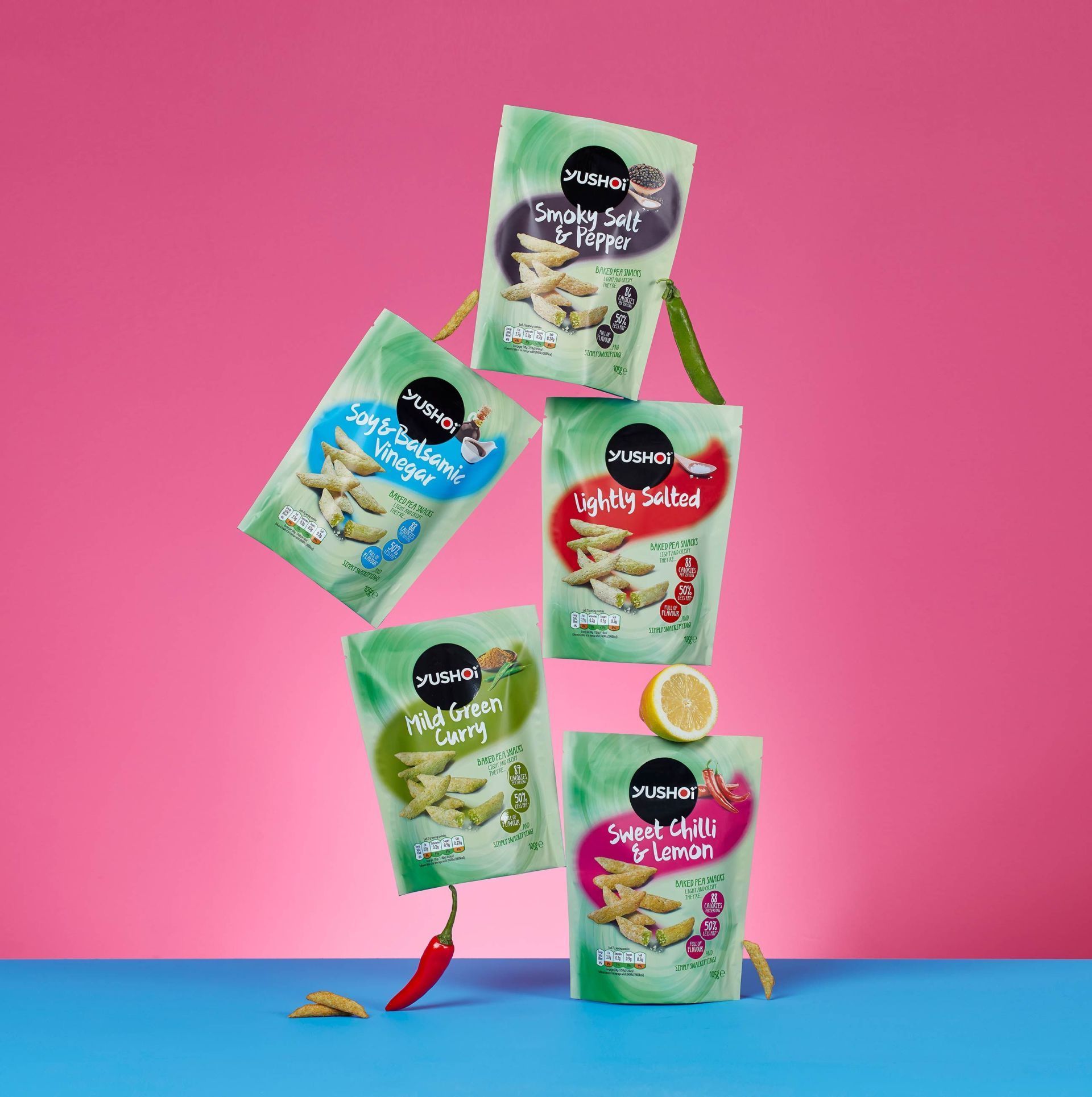 A bunch of bags of food are stacked on top of each other on a table.