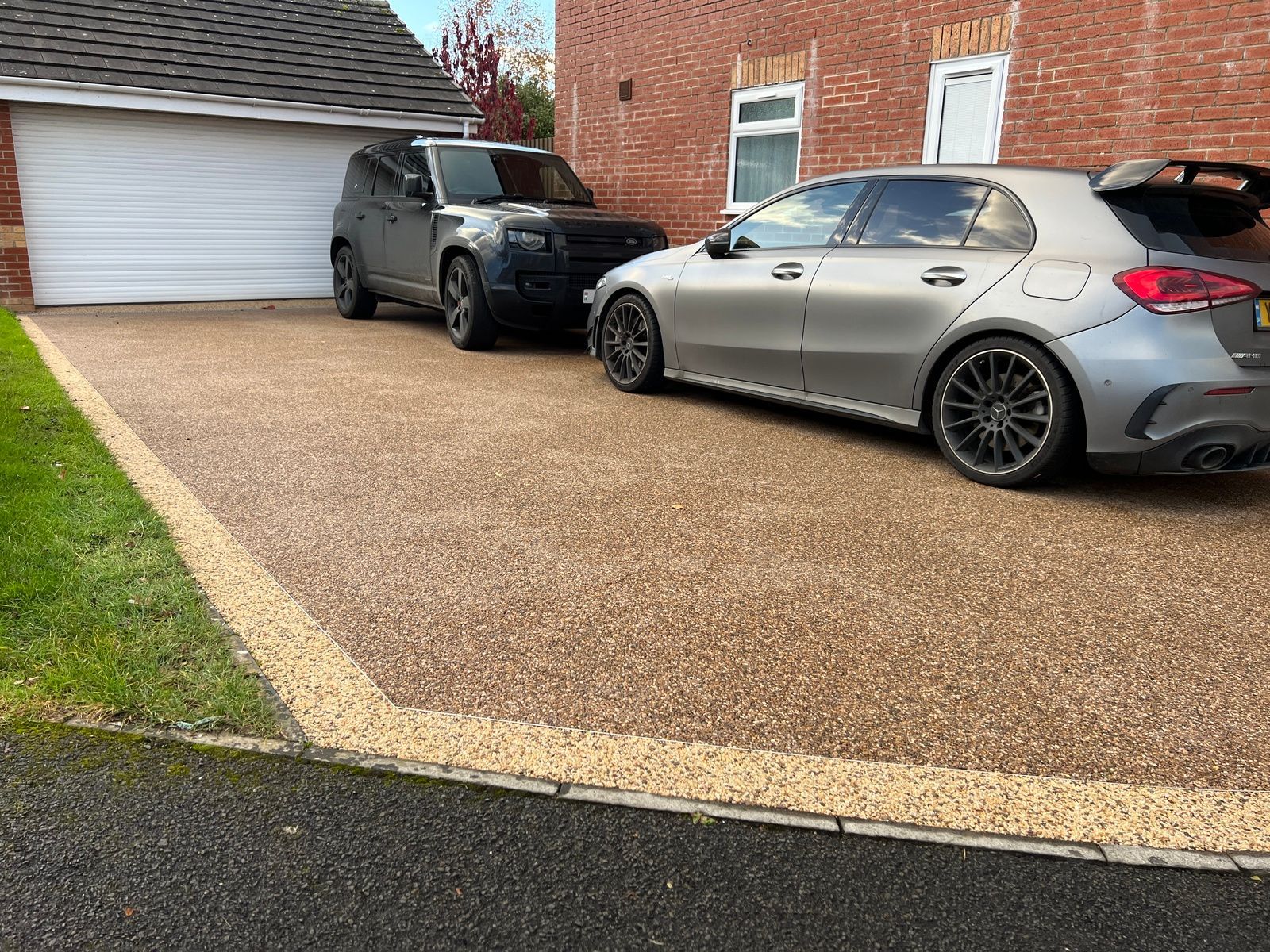 Brown resin driveway with 2 cars parked on top