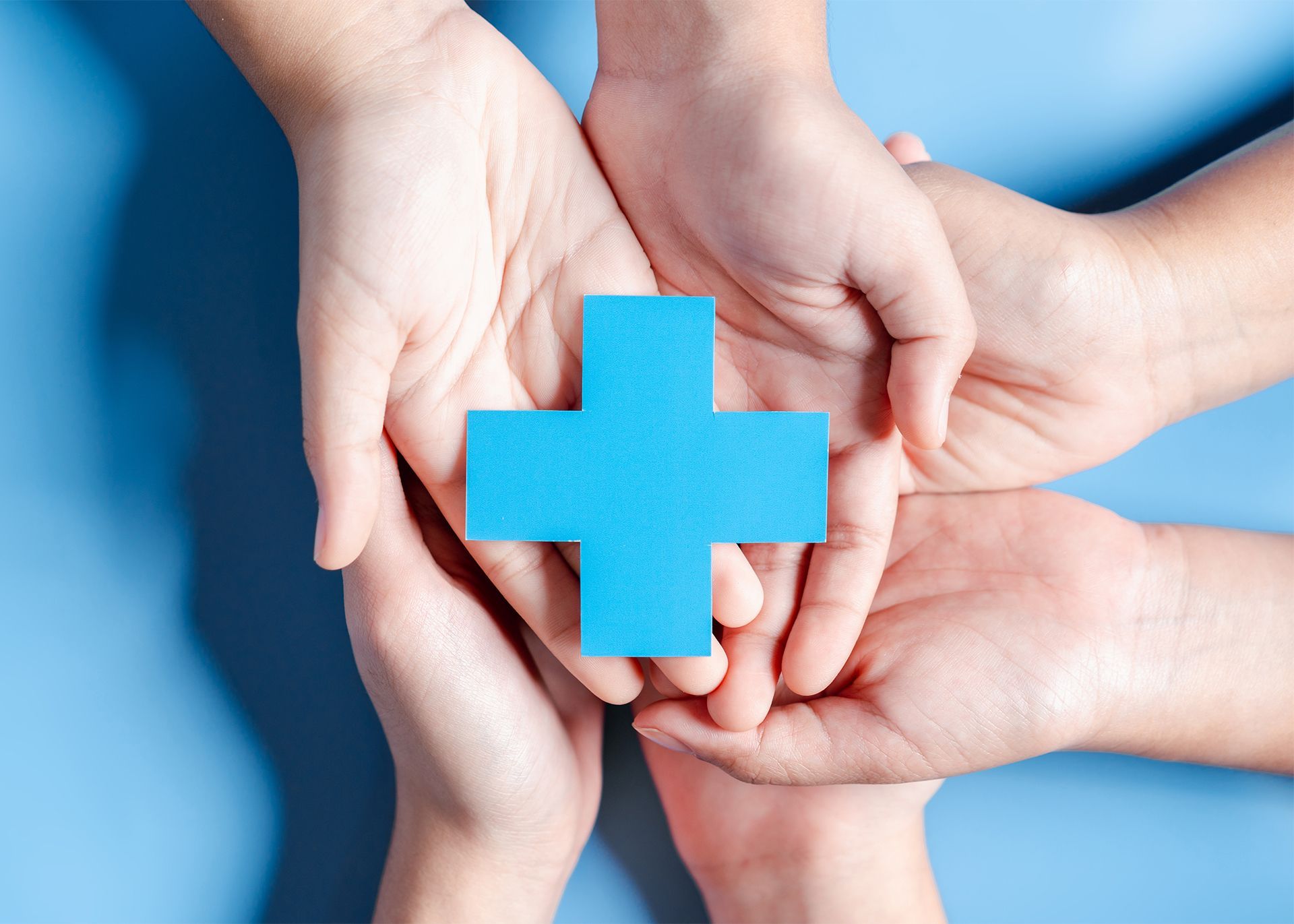 blue cross over family's hands