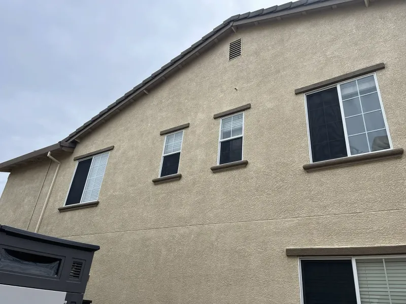 A house with a lot of windows and a mailbox on the side of it.
