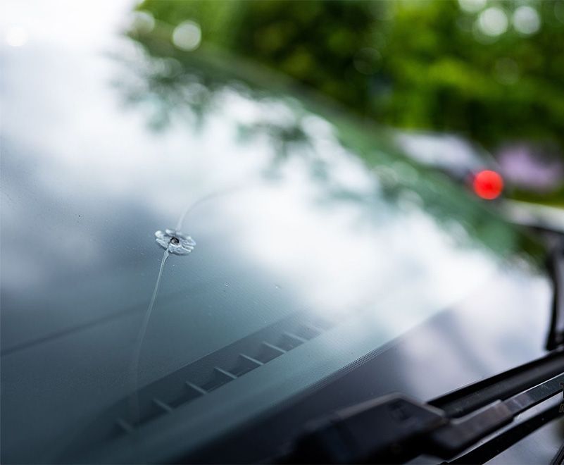 A close up of a broken windshield on a car.