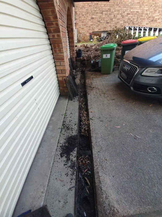 Bafore Cleaning The Gutter On The Garage — Gutter Cleaning Services in Terrace, NSW