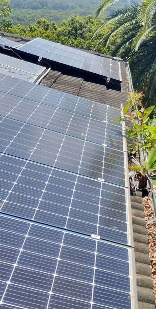 There Are Many Solar Panels on the Roof of a Building — TK Guttercleaning in Hamlyn Terrace, NSW
