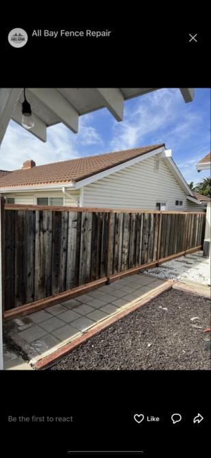 a wooden fence is in front of a house .