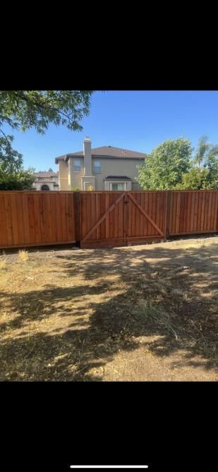 a wooden fence is in front of a house .