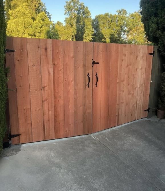 a black metal fence is in front of a building .