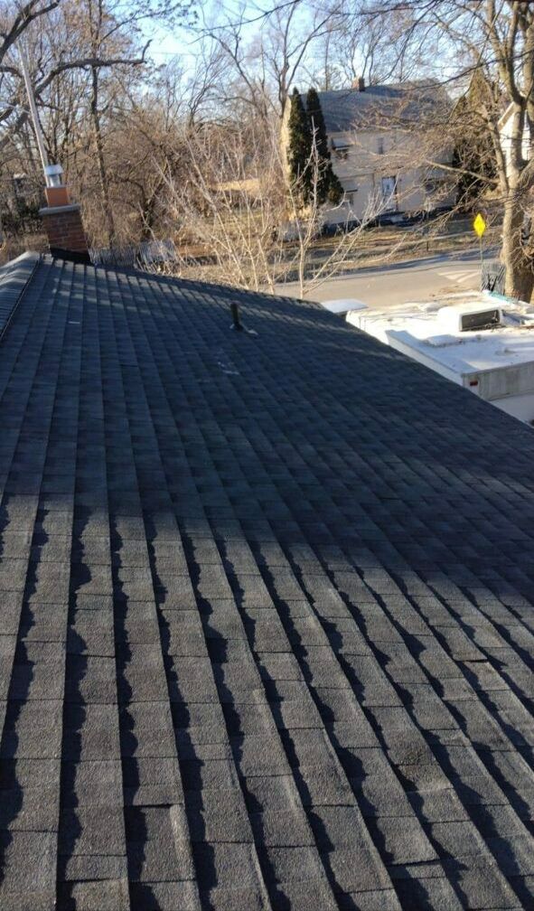 A close up of a roof with a chimney on it.