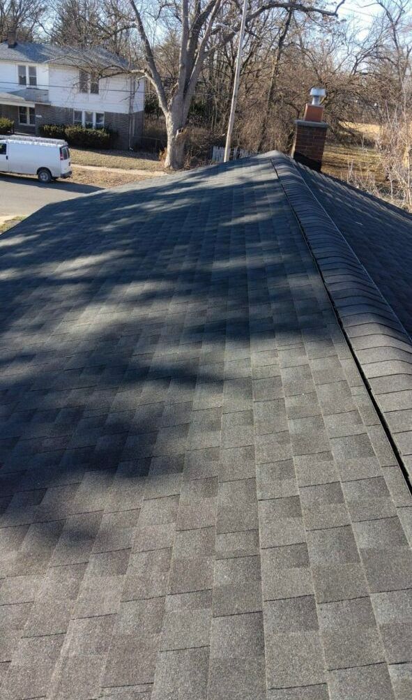 A van is parked on the side of the road next to a roof.