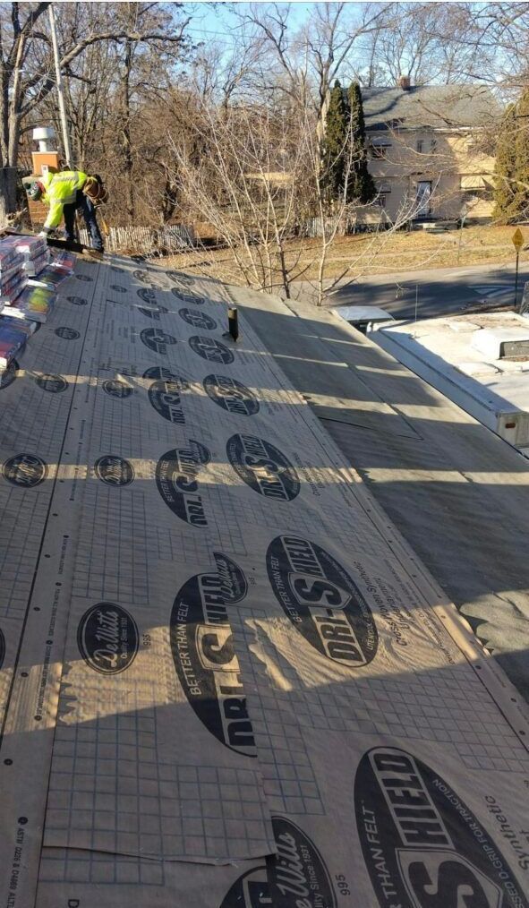 A man is working on the roof of a house.