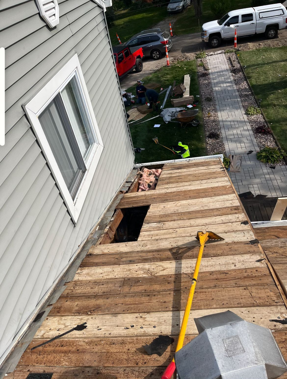 A wooden roof is being removed from a house.