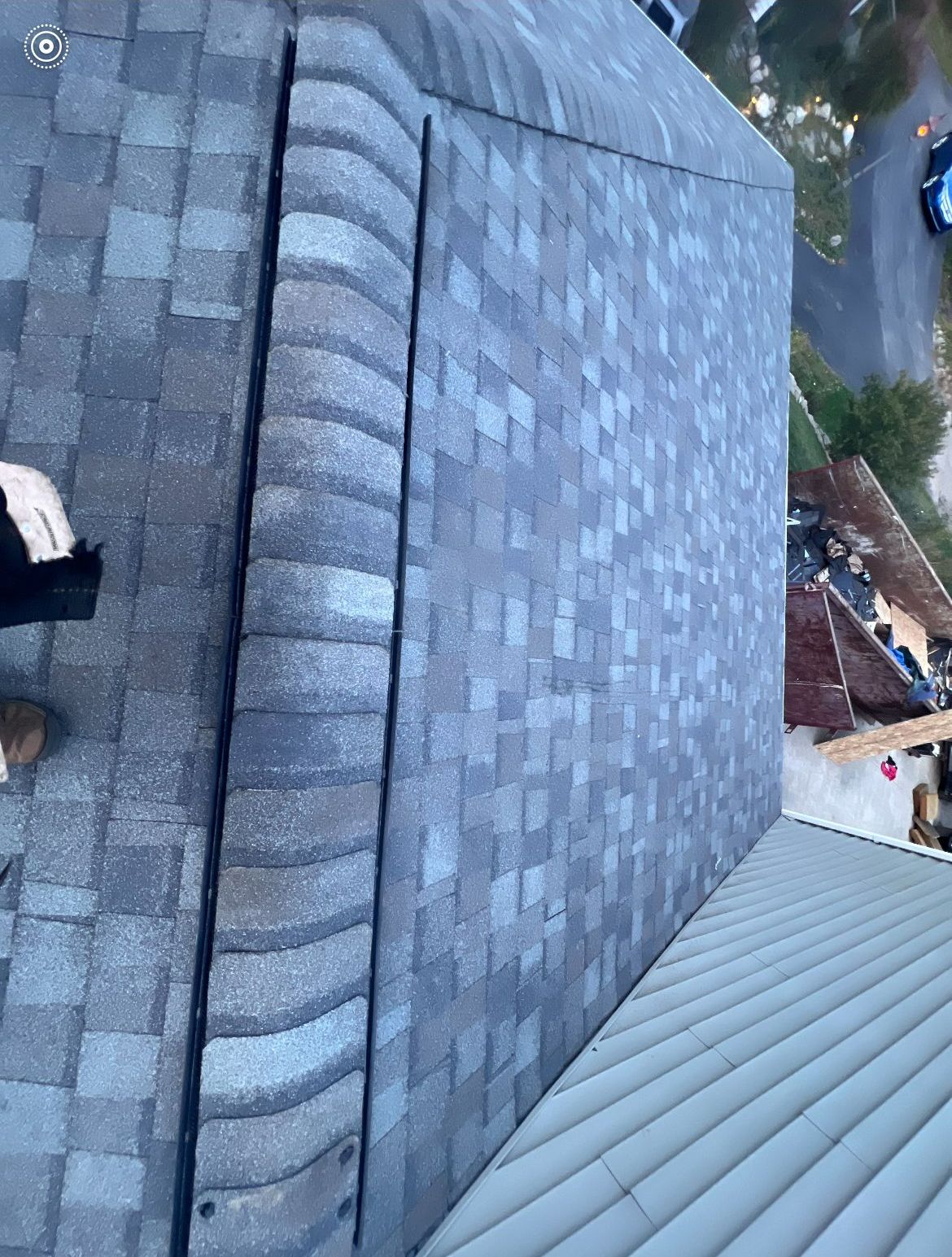 A person is standing on the roof of a building.