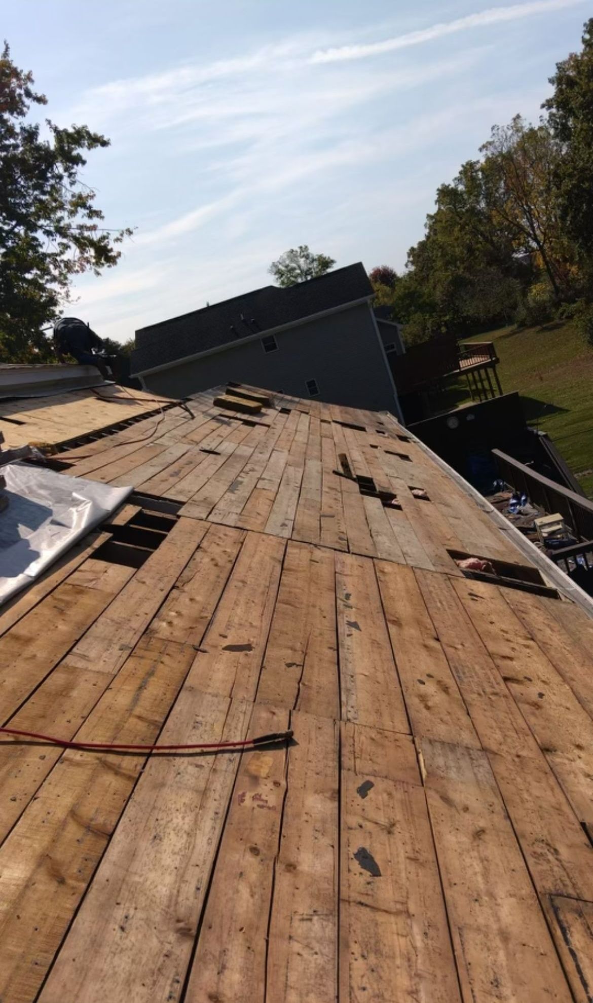 A wooden deck is being built on top of a house.
