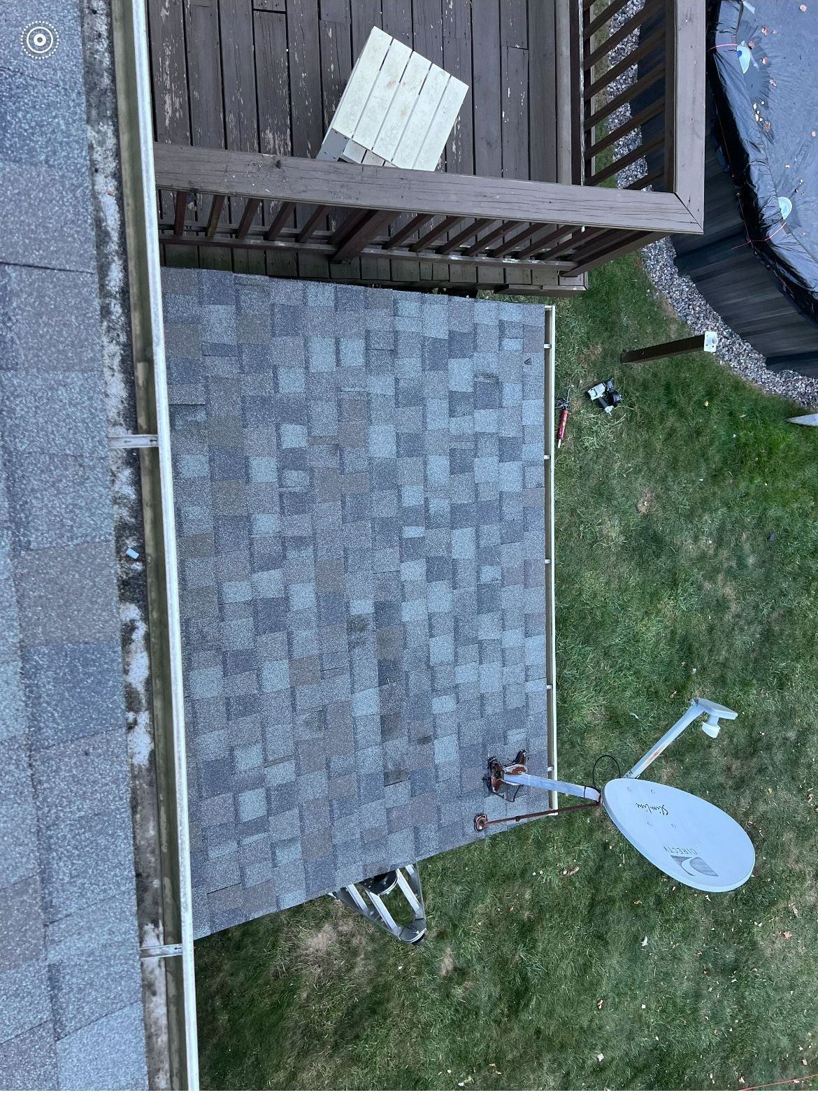 An aerial view of a roof with a satellite dish on it.