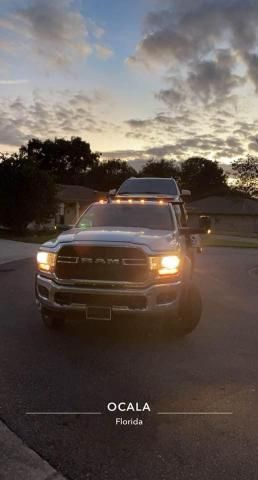 A tow truck is parked in a driveway at sunset.