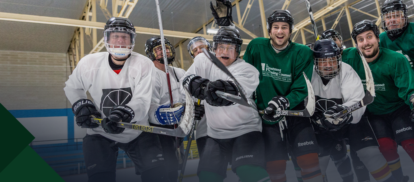 A group of people playing hockey