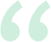 A pair of green quotation marks on a white background.