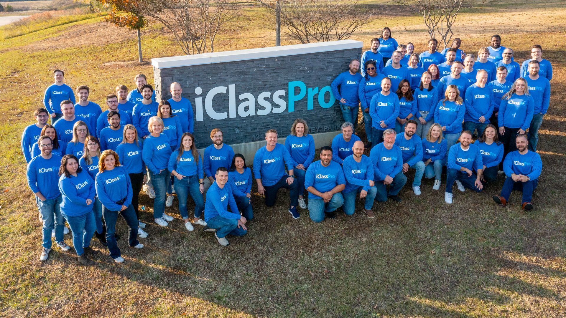 iClassPro Team in front of iClassPro HQ Sign