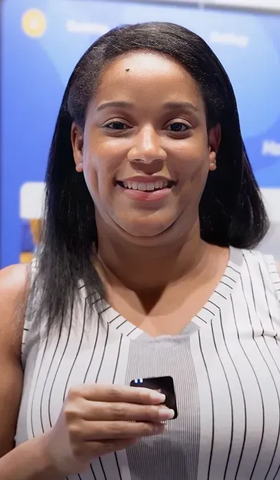 A man with a beard is wearing a lanyard around his neck.