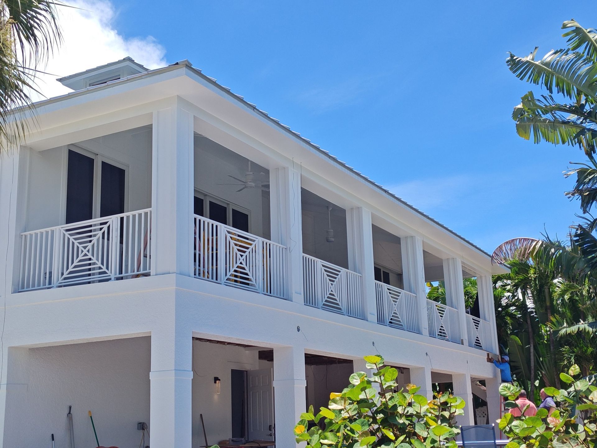 A large white house with a blue sky in the background