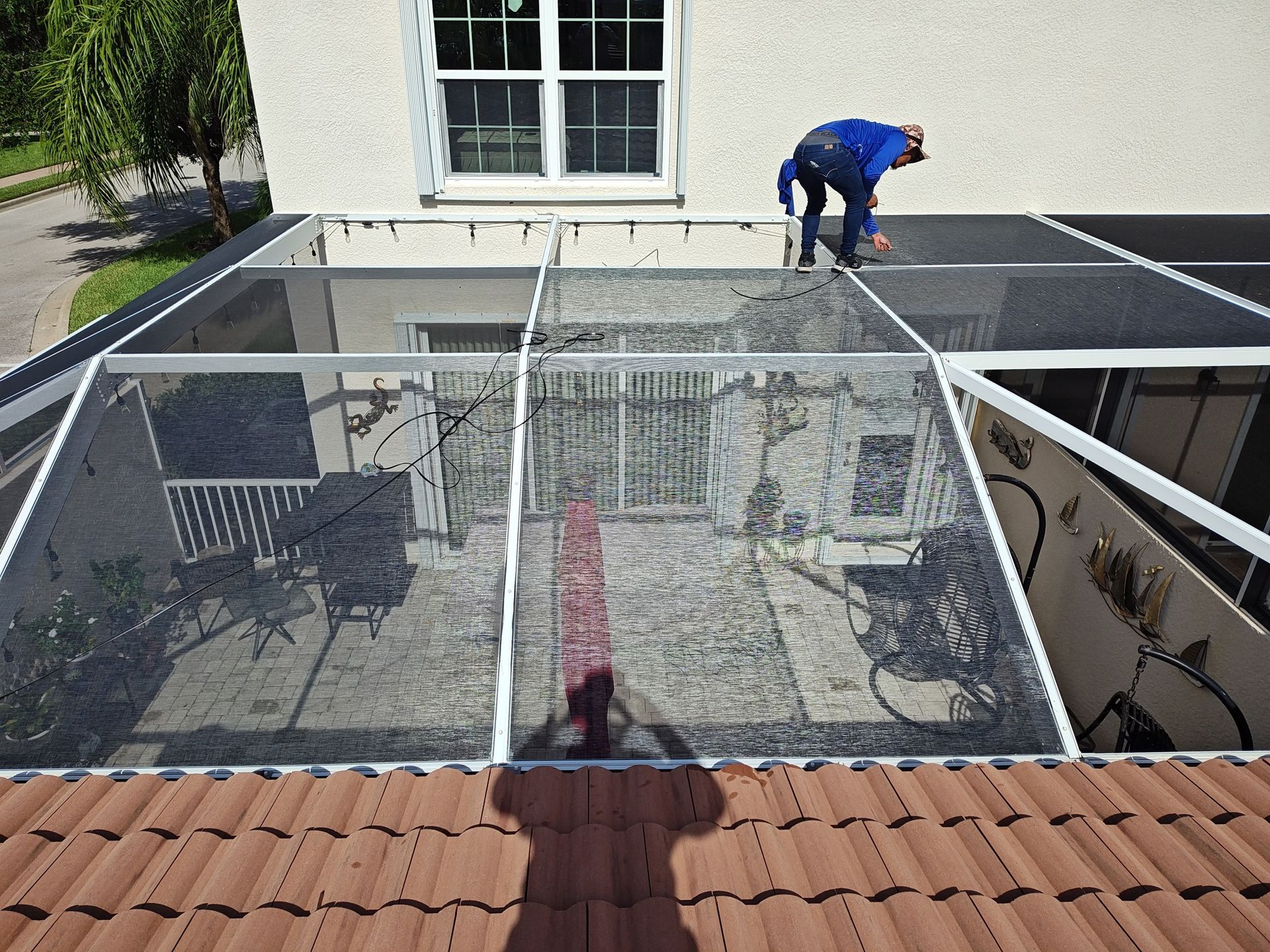 A man is working on the roof of a house.